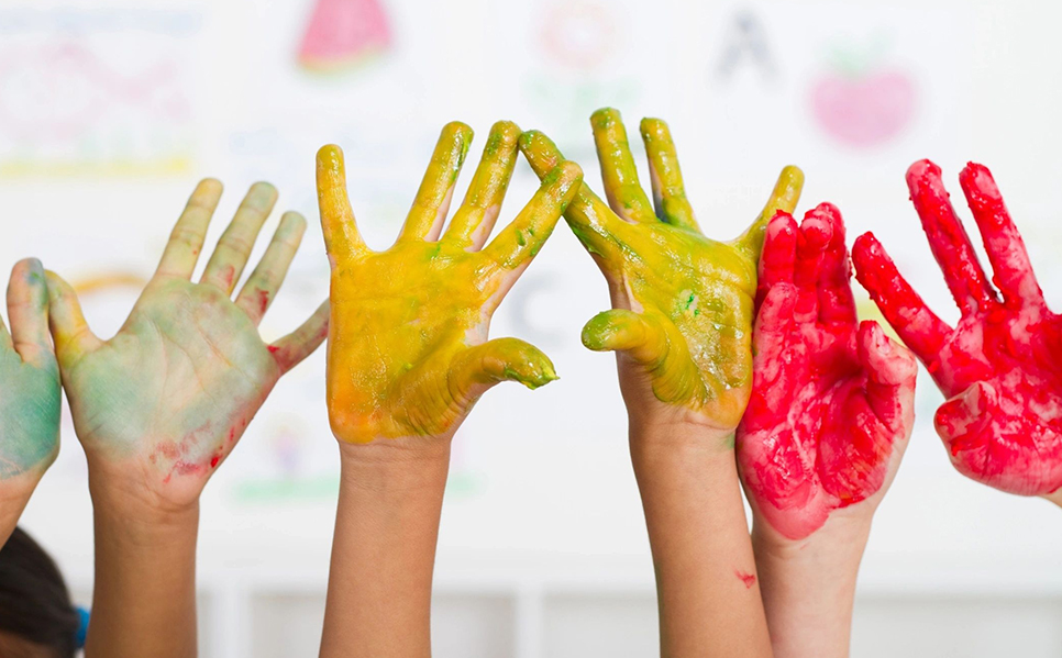 Kids showing vibrant painted palms
